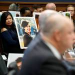 Family members of people who died in crashes of the Boeing 737 Max hold photographs of their lost loved ones as FAA Administrator Stephen Dickson testifies during a House Transportation Committee hearing Wednesday in Washington. (AP Photo/Jacquelyn Martin)