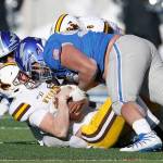 Air Force defensive lineman Mosese Fifita (top) sacks Wyoming quarterback Levi Williams during the Falcons 20-6 win over the Cowboys on Nov. 30 in Colorado Springs. (AP Photo/David Zalubowski)