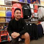 Victor Duran, a co-manager of a sports apparel store at the Southcenter mall, south of Seattle, poses for a photo at the store Dec. 11 in Tukwila. Duran, 23, said he makes about $52,000 a year and doesnt get overtime, but is required to work at least 45 hours per week, and up to 60 during the holidays. (AP Photo/Elaine Thompson)