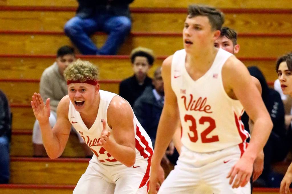 Marysville-Pilchucks Cameron Stordahl celebrates a score with teammate Aaron Kalab Wednesday evening at Marysville-Pilchuck High School in Marysville on December 11, 2019. The Tomahawks won 67-58. (Kevin Clark / The Herald)