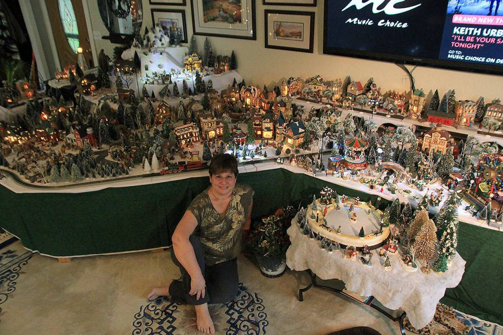 It takes Tammy Butler about 10 days, working about four hours each day, to complete the not-so-tiny-anymore tiny town. (Laura Guido/Whidbey News-Times)