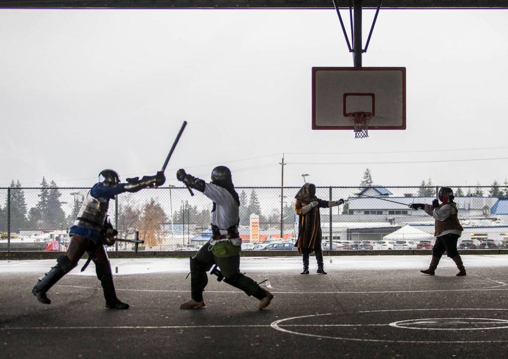 Members of the Barony of Aquaterra practice at Evergreen Middle School in Everett. The Barony is the Snohomish County chapter of the Society for Creative Anachronism. (Olivia Vanni / The Herald)