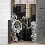A worker inside Seattle Barrel and Cooperage works on a barrel just inside the large open-door shop Wednesday in Seattle. The century-old Seattle barrel company has been indicted along with its third-generation owner in what prosecutors describe as a long-running pollution conspiracy. (AP Photo/Elaine Thompson)