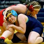 Snohomishs Madi Marshall (top) wrestles and pin Arlingtons Souzanna Crew Wednesday evening at Arlington High School in Arlington on December 18, 2019. Arlington beat Snohomish/Glacier Peak 66-18. (Kevin Clark / The Herald)