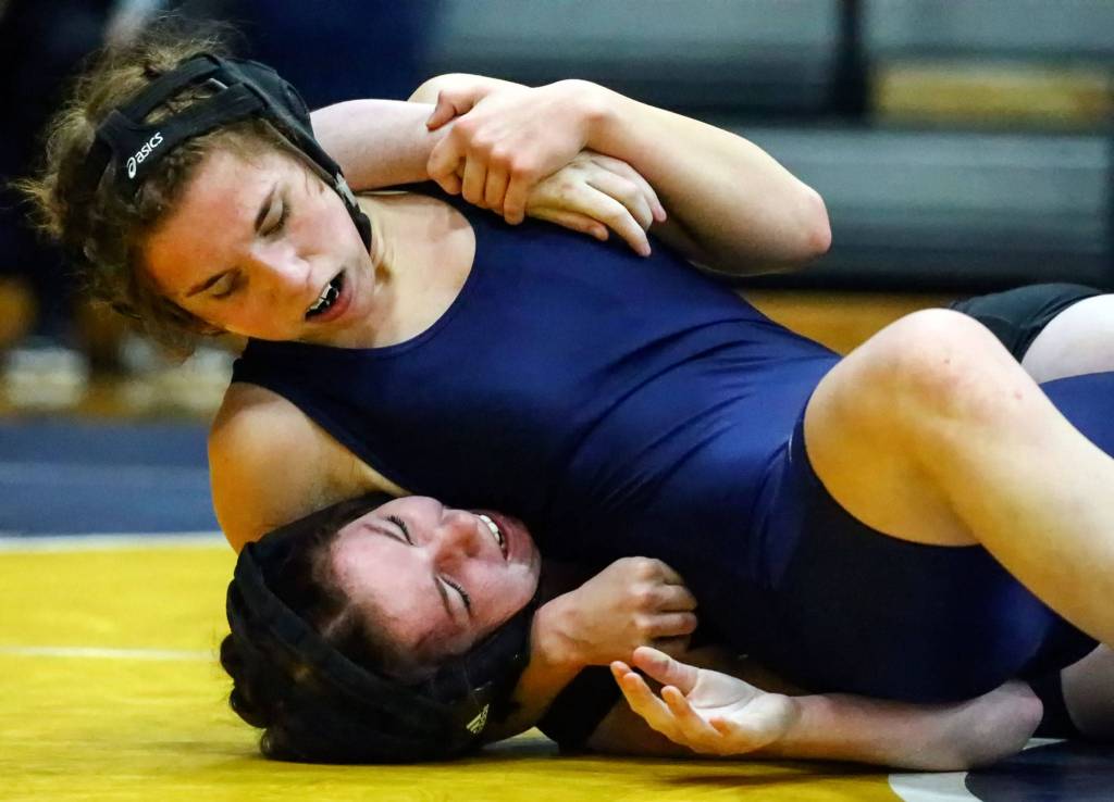Arlingtons Hailey Latta wrestles and pins Marysville Getchells Kaitlan Flick Wednesday evening at Arlington High School in Arlington on December 18, 2019. Arlington won 60-18. (Kevin Clark / The Herald)