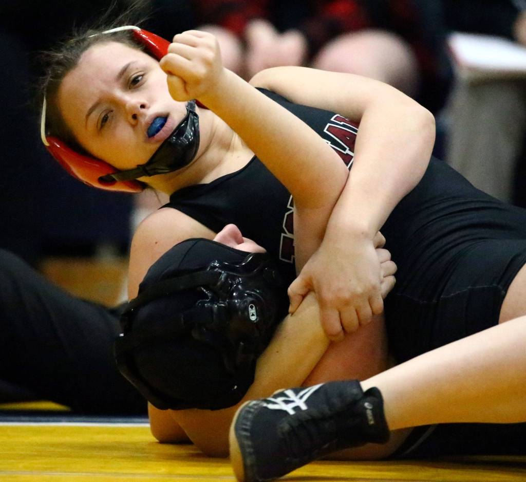 Marysville Pilchucks Chelsey Goeden wrestles and pins Arlingtons Raina Allen Wednesday evening at Arlington High School in Arlington on December 18, 2019. Arlington won 60-18. (Kevin Clark / The Herald)