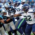 Seahawks running back Chris Carson (32) runs while Panthers defensive back Ross Cockrell (47) chases during the second half of a game Dec. 15 in Charlotte, N.C. (AP Photo/Brian Blanco)
