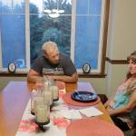In this Aug. 21 photo, Stacy Mullen-Deland (right), a former Spanish teacher at Sky Valley Education Center, and her husband, Eric, eat dinner in their home in Snohomish. The couple is part of a lawsuit filed against the school district, the local health department and Monsanto, the maker polychlorinated biphenyls, or PCBs, which several families believe have made them sick. (AP Photo/Ted S. Warren, file)