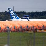In this Oct. 3 photo, completed Boeing 737 Max fuselages, made at Spirit Aerosystems in Wichita, Kansas, sit covered in tarps near the factory. (Travis Heying/The Wichita Eagle via AP File)