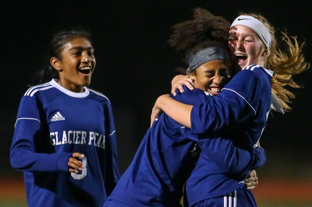 Glacier Peaks Aaliyah Collins celebrates her goal with Kate Sprink (right) and Abigail Varghese (left) at Glacier Peak High School in Snohomish on Sept. 24. (Kevin Clark / The Herald)