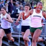 Jacksons Amaya Poole (right) celebrates after winning the 100-meter dash during the 3A & 4A NW District Track and Field Championships at Shoreline Stadium on May 17. (Kevin Clark / The Herald)