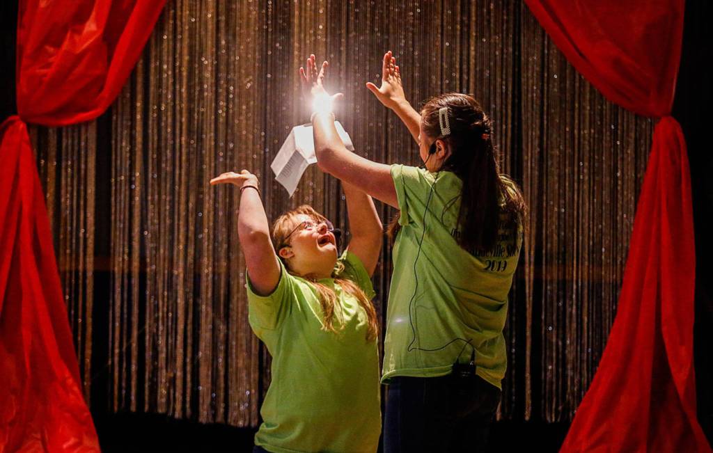At the end of a rousing performance of the song You Are Holy, Faith Fitch (left) and Angelina Nesterenko end with a high-five. (Dan Bates / The Herald)