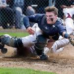 Arlingtons Jack Sheward is hit in the leg as ODeas David Sessoms slides in for the tying run in a 3A baseball state regional game at Sherman Anderson Field on May 18 in Mount Vernon. (Andy Bronson / The Herald)