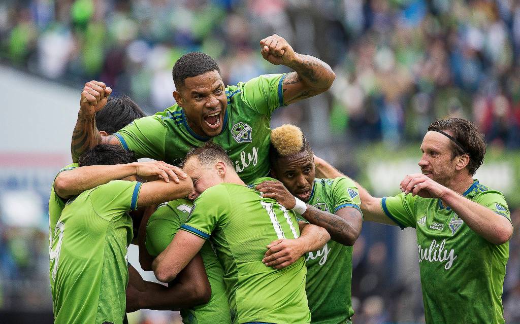Sounders players celebrate the first goal by Kelvin Leerdam as the Seattle Sounders beat Toronto FC 3-1 to win the MLS Cup at CenturyLink Field on Nov. 10. (Andy Bronson / The Herald)