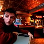 From the Edmonds Theaters distinctive Art Deco lobby, employee Jack Eccleshall, 18, glances out the window. (Dan Bates / The Herald)