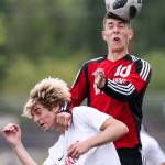 Kamiakins Garrett Grillo is blocked from a header by Marysvilles Kyle Matson at Quil Ceda Stadium in Marysville on May 14. (Kevin Clark / The Herald)