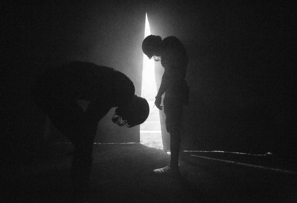 Monroe High School football players wait inside a tunnel for their names to be called before their game on Nov. 9 in Monroe. (Olivia Vanni / The Herald).