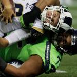 Rams quarterback Jared Goff is tackled by Seahawks defensive tackle Al Woods (bottom) during the second half of a game Oct. 3, 2019, in Seattle. (AP Photo/Stephen Brashear)