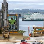 A construction worker in heavy equipment Sept. 11 excavates on the site of the new Mukilteo Ferry Terminal, which is set to open in late October 2020. (Kevin Clark / The Herald)