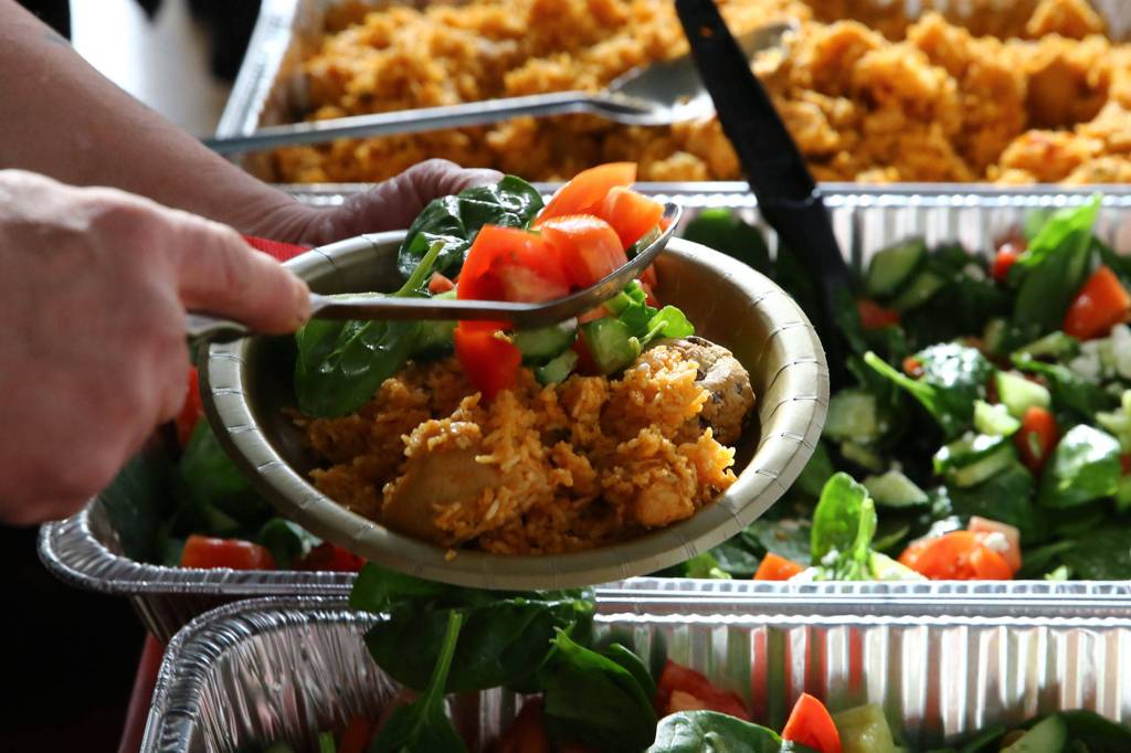 Edmonds chef Shahzad Raja brought food to Housing Hope in Everett on Tuesday. (Kevin Clark / The Herald)