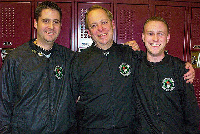 Rick Myers (center) poses for a photo with nephew Mark (left) and son Chris (right) in 2006 in a locker room at Archbishop Murphy High School. The three Myers family members officiated together that night for the final game of Ricks 25-year career. (Photo provided by the Myers family)