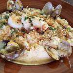 The seafood risotto bowl is filled with prawns, scallops and clams, and topped with a panko crust and Parmesan. (Sharon Salyer / The Herald)