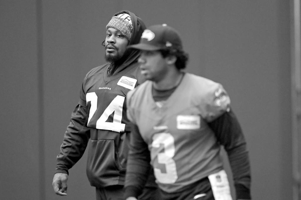 Elaine Thompson / Associated Press                                Seattle running back Marshawn Lynch (left) looks across at Seahawks quarterback Russell Wilson during the teams practice Tuesday in Renton.
