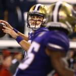 Washingtons Jacob Eason eyes teammate Salvon Ahmed for a pass against California at Husky Stadium in Seattle on Sept. 7. (Kevin Clark / Herald file)