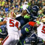 Seattle Seahawks Marshawn Lynch leaps the line for a touchdown against the 49ers Sunday evening at CenturyLink Field in Seattle on December 29, 2019. The 49ers won 26-21. (Kevin Clark / The Herald)