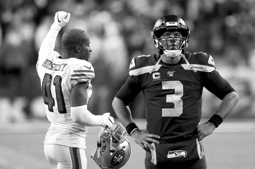 Kevin Clark / The Herald                                Seattle quarterback Russell Wilson watches the replay as San Franciscos Emmanuel Moseley celebrates the 49ers 26-21 win Sunday at CenturyLink Field.