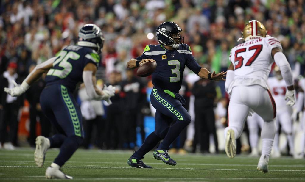 Seattle Seahawks Russell Wilson runs forward to throw a touchdown pass as the Seattle Seahawks lost to the San Francisco 49ers 26-21 at CenturyLink Field on Sunday, Dec. 29, 2019 in Seattle, Wash. (Andy Bronson / The Herald)