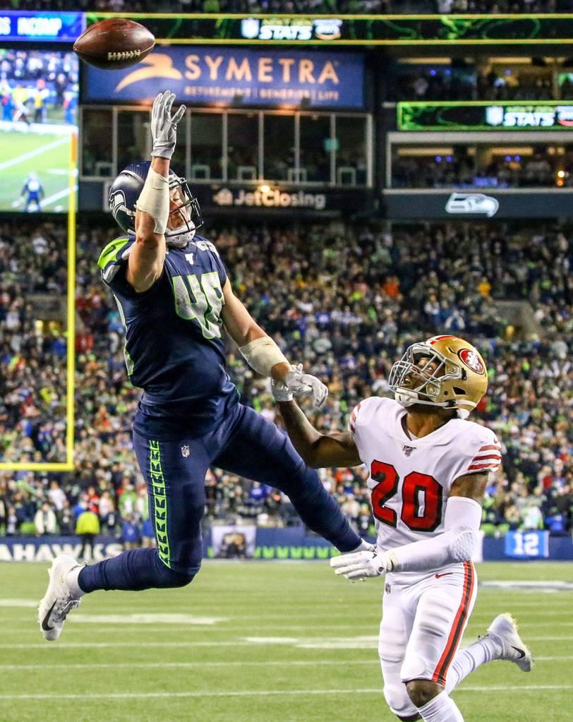 Seattle Seahawks Jacob Hollister jumps for pass with San Franciscos Jimmie Ward trailing Sunday evening at CenturyLink Field in Seattle on December 29, 2019. The 49ers won 26-21. (Kevin Clark / The Herald)