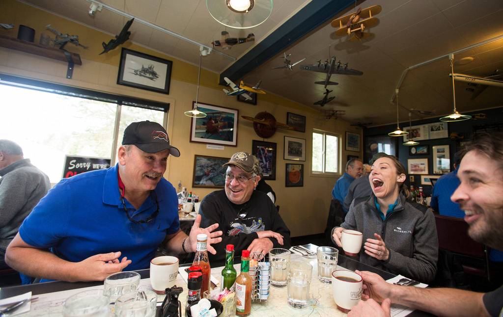 After flying in from Arlington, pilot Todd Bohon gets a laugh from fellow pilots (from left) Dan Tarasievich, Trisa Jackson and Ryan LaPointe during breakfast at the Spruce Goose Cafe in Port Townsend. (Andy Bronson / Herald file)