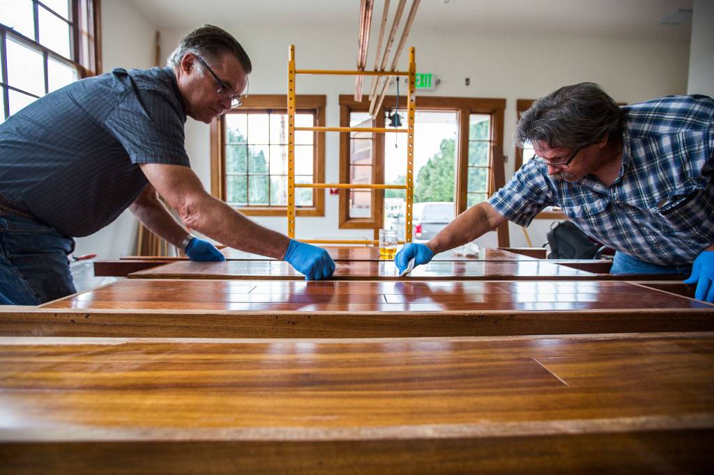 Richard Bergman (left) helps Rick Cross finish the bathroom partitions that will be installed in the renovated Startup Event Center. (Olivia Vanni / Herald file)