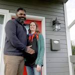 Kate and Quantas Ginn pose for a photo at their home in Tacoma. Kate Ginn, who is expecting a baby in late January, is planning to submit paperwork on Thursday to apply for paid time off under Washington states new paid family leave law. (AP Photo/Ted S. Warren)