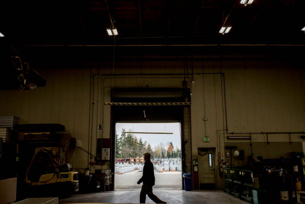 A PUD worker walks through the warehouse that stores millions of dollars worth of supplies that can be dispatched quickly during storms at the Snohomish County PUD Operations Center in Everett. (Olivia Vanni / The Herald)