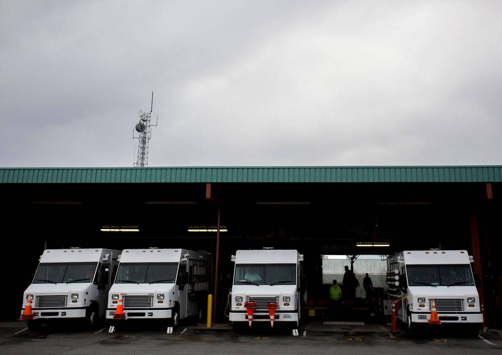 Line trucks sit parked after a work day at the Snohomish County PUD Operations Center in Everett. (Olivia Vanni / The Herald)