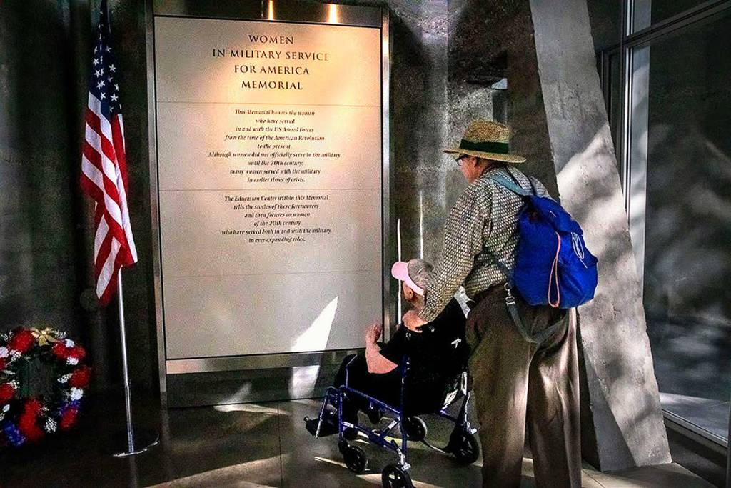 Teresa Schmierer, helped by her son, Mike Schmierer, reads about the Women in Military Service for America Memorial during her Puget Sound Honor Flight trip to Washington, D.C., last September. The 100-year-old served as a Navy nurse during World War II. (Puget Sound Honor Flight)