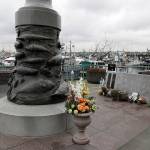 The Seattle Fishermens Memorial is shown Thursday in Seattle. Items left at the memorial Thursday included a ball cap with the name of the crab fishing boat Scandies Rose. (AP Photo/Ted S. Warren)
