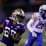 Washington running back Salvon Ahmed (26) carries the ball past Boise State defensive back Kekaula Kaniho (28) during the second half of the Las Vegas Bowl on Dec. 21, 2019, in Las Vegas. (AP Photo/Steve Marcus)