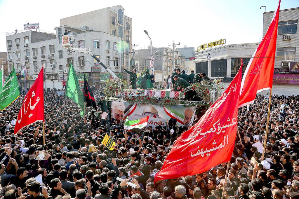 In this photo provided by The Iranian Students News Agency, ISNA, flag draped coffins of Gen. Qassem Soleimani and his comrades who were killed in Iraq in a U.S. drone strike, carried on a truck surrounded by mourners during their funeral Sunday in southwestern city of Ahvaz, Iran. The body of Soleimani arrived Sunday in Iran to throngs of mourners, as U.S. President Donald Trump threatened to bomb 52 sites in the Islamic Republic if Tehran retaliates by attacking Americans. (Alireza Mohammadi/ISNA via AP)