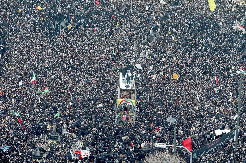 Coffins of Gen. Qassem Soleimani and others who were killed in Iraq by a U.S. drone strike, are carried on a truck surrounded by mourners Sunday during a funeral procession, in the city of Mashhad, Iran. Soleimanis death Friday in Iraq further heightens tensions between Tehran and Washington after months of trading attacks and threats that put the wider Middle East on edge. (Mohammad Hossein Thaghi/Tasnim News Agency via AP)