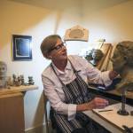 Judeth Davis works on a bust at her studio in Granite Falls. (Olivia Vanni / The Herald)