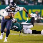 Seattles Russell Wilson (3) runs away from Philadelphias Nigel Bradham (53) during an NFC wild-card playoff game on Sunday in Philadelphia. (AP Photo/Chris Szagola)
