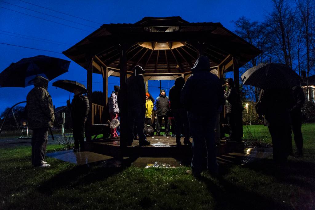 People stand around and wait for the union contract negotiation vigil to start at Northwest Everett Neighborhood Park across from Providence Region Medical Center Everett on Wednesday. (Olivia Vanni / The Herald).