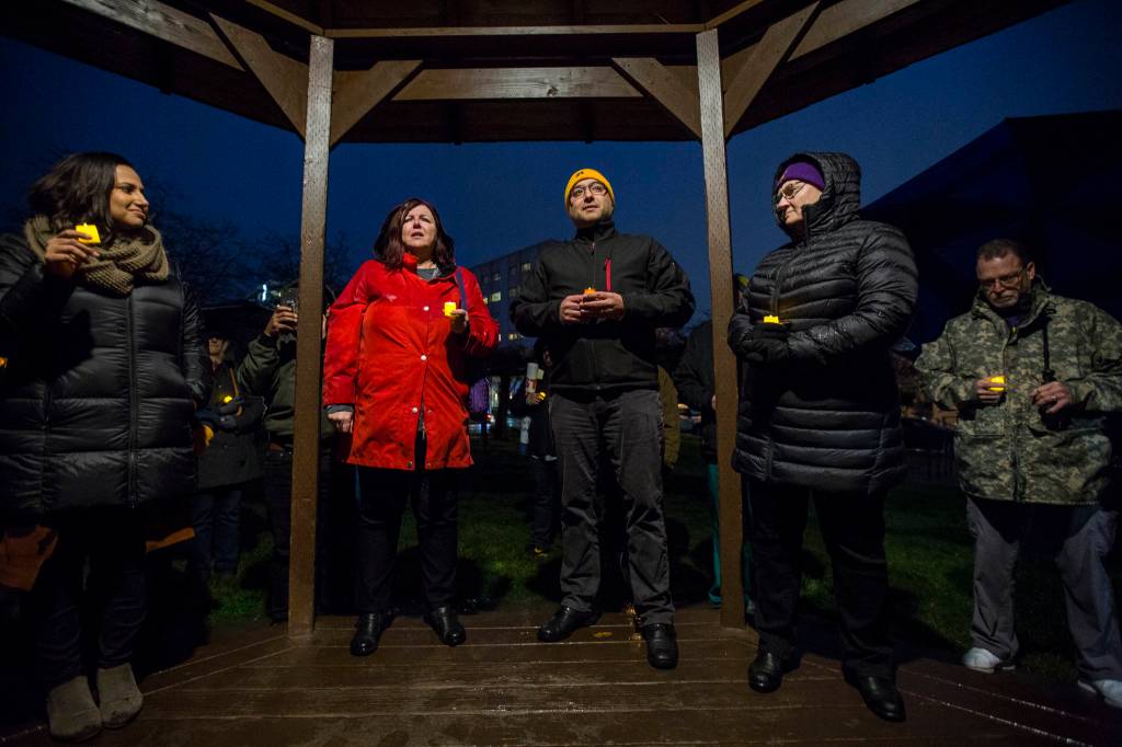 UFCW 21 representatives Cathy Macphail (left), Anthony Cantu (center) and Home Health and Hospice worker Debi Schmidt (right) talk during a union contract negotiation vigil at Northwest Everett Neighborhood Park on Wednesday. (Olivia Vanni / The Herald).