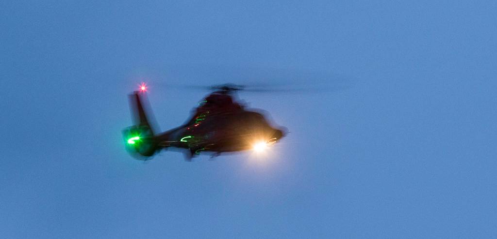 Divers and other rescue personnel search for a man who was last seen swimming to shore after his inflatable boat capsized off the beach north of the Mukilteo ferry Wednesday. (Andy Bronson / The Herald)