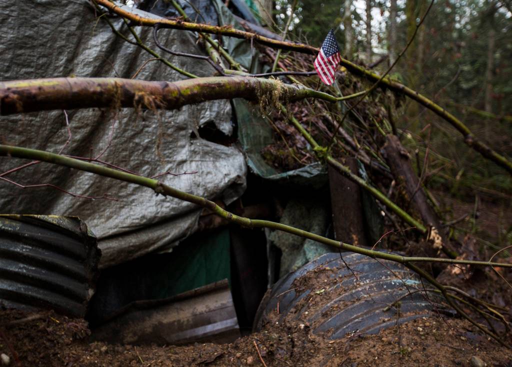 A small American flag sticks off a branch outside the dwelling Thursday in Monroe. (Olivia Vanni / The Herald)