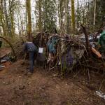 Sgt. Paul Ryan looks inside the dwelling as Officer Scott Kornish shines his light to ensure no one is inside Thursday in Monroe. (Olivia Vanni / The Herald)