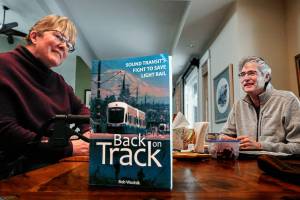 In her Mill Creek area home, Joni Earl, former Sound Transit CEO, and author Bob Wodnik talk about the transit agencys decades-long effort to bring light rail to the region. Wodnik, a former Herald writer, has written Back on Track, a new book about the battles for light rail. (Dan Bates / The Herald)